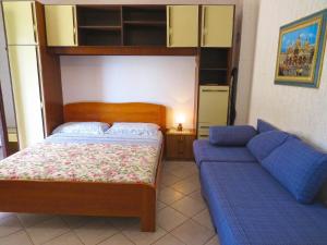 梅杜林Ferienwohnung für 2 Personen ca 28 qm in Medulin, Istrien Südküste von Istrien的一间卧室配有一张床和一张沙发
