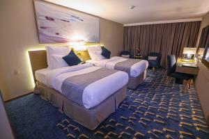 Cheerful Al Waha Hotel Unayzah - فندق شيرفل عنيزة客房内的一张或多张床位