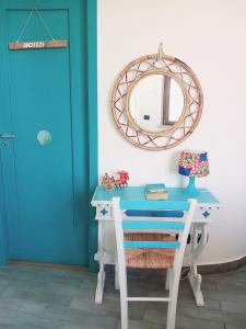 蒙德罗Villa Mondello Terraces & Jacuzzi的一张带镜子的蓝色书桌和一扇蓝色门