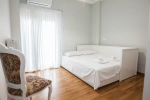 雅典Brand new apt in Zografou的白色卧室配有床和椅子