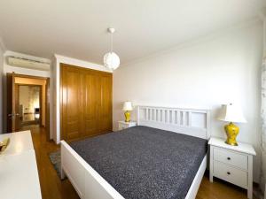 里斯本Luxury Apartments in Expo的一间卧室设有一张大床和两个床头柜