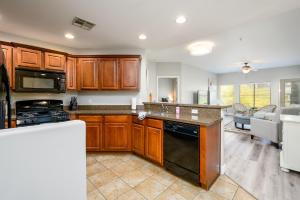 凤凰城Villa Desert Ridge condo的厨房配有木制橱柜和炉灶烤箱。