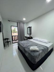 巴佐Chalet Barokah Resort, Bachok的一间卧室配有一张床、一张书桌和一台电视