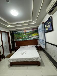 胡志明市Hoàng Thiên Lộc Hotel -199 Hoàng Hoa Thám, Q. Tân Bình - by Bay Luxury的一间设有一张床的客房,墙上挂着一幅画