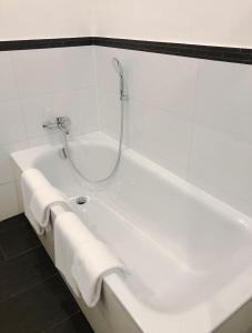 圣马丁Sebalds Apartments Zentrum Sankt Martin的白色浴缸,配有2条白色毛巾