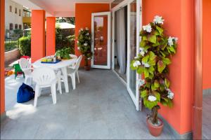 罗索利纳马雷Principesse的庭院配有白色的桌椅和植物