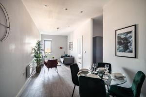 锡福斯Modern & Spacious 2 Bed Apartment in Waterloo Liverpool的用餐室以及带桌椅的起居室。