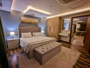伊斯兰堡Executive One Bedroom Apartment Opposite Centaurus Mall Islamabad的一间大卧室,配有一张大床和一张沙发