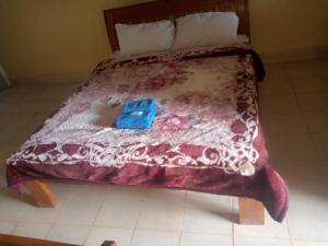 IsuvyaPrudent Guest House的一张带红色和白色棉被的床