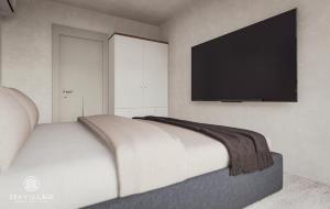 那沃达利SeaVillage的卧室配有一张壁挂式平面电视的床。