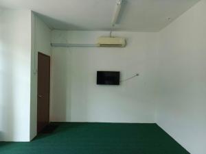 Kampong Tebing RabakHASD GUESTHOUSE的一间拥有白色墙壁和墙上电视的房间
