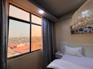 朱巴EASTERN PLAZA HOTEL的客房设有窗户和一张享有美景的床。