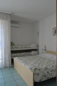 加尔达湖滨安布拉公寓酒店的一间卧室设有两张床和窗户。