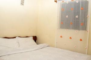 EmbuHilda's place的一间卧室配有床和一个带橙色蝴蝶的窗户
