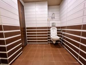 西姆拉The G.S. Cottages的浴室设有棕色和白色条纹的卫生间
