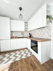 兹拉托格勒Апартамент за гости Лена Златоград的白色的厨房配有白色橱柜和水槽