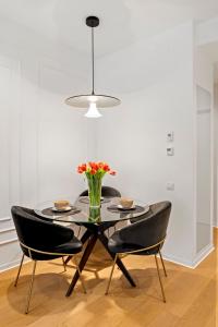 布加勒斯特ONE Luxury Apartments的餐桌、椅子和花瓶