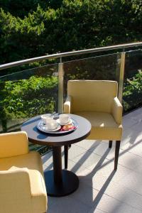 帕兰加波罗的酒店的阳台配有一张桌子和两把椅子