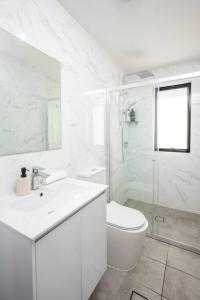 IngleburnLovely 4 bedrooms house to Ed station的白色的浴室设有卫生间和水槽。
