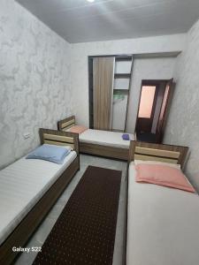 撒马尔罕Hostel Highway的带两张床和镜子的客房