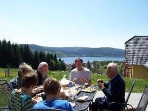 伏尔塔瓦河畔利普诺Ferienhaus für 10 Personen in Lipno nad Vltavou, Böhen Moldau的一群坐在桌子旁吃饭的人