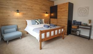 伊斯特布恩Aqua nest Eastbourne的一间卧室配有一张床和一张蓝色椅子