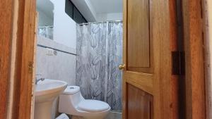 库斯科Hotel Qori Punku的一间带卫生间和淋浴帘的浴室