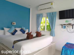 拉迈普汉纳度假村的蓝色和白色的客房内的两张床