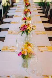 VillastradaPorsenna Resort的花瓶长桌子,上面布满了鲜花