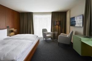 圣马丁文思领事馆酒店的酒店客房带床、椅子和窗户