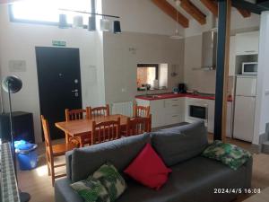埃斯皮尔多Casa Rural - De Brevas a Higos的带沙发和桌子的客厅以及厨房。