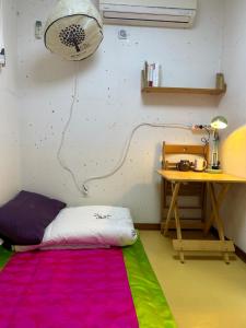 首尔Eugene Hanok Stay的一间设有床铺、书桌和地毯的房间