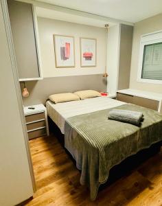 佩洛塔斯Apartamento Acqua, 102 A, com vaga de garagem的一间卧室设有一张大床和一个窗户。