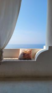 RinellaSalina Castel Vinci的窗户窗台,带枕头,享有大海美景
