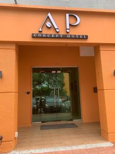 八打灵再也AP Concept Hotel的一座橙色的建筑,有汽车经销商的入口