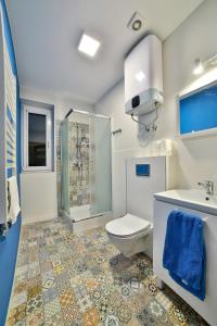 新塔尔格Apartamenty KOMBI的浴室配有卫生间、淋浴和盥洗盆。