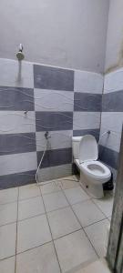 话毛生Sobey Laris Roomstay GUA MUSANG的一间带卫生间和棋盘墙的浴室