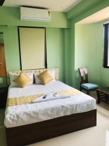孟买Everest Stays Rooms and Dormitory的绿色墙壁间的一张床位