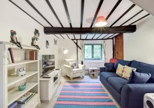 斯科尔The Cottage的客厅配有蓝色的沙发和电视