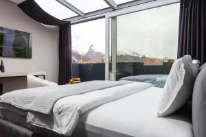普里兹伦Morea Hotel的一间卧室设有两张床和大窗户
