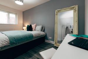 利物浦Park & Relax in 1bd Central Liverpool home的一间卧室配有一张床和镜子