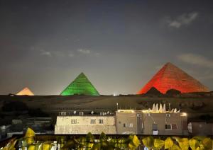 开罗Solima Pyramids View的一组金字塔,用红色和绿色点亮
