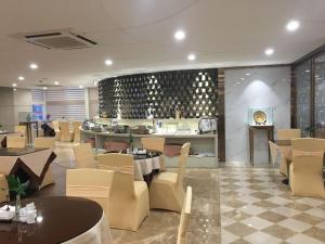 深圳深圳罗湖田贝明阳酒店的一间带桌椅和柜台的餐厅