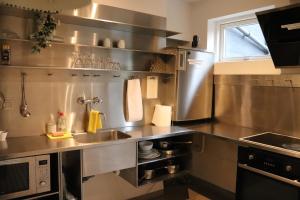 欧登塞Milling Hotel Mini 11的不锈钢厨房,配有水槽和微波炉