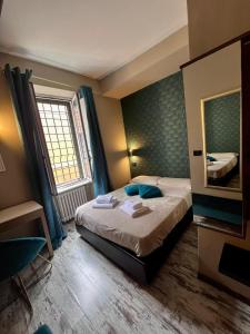 罗马多莫斯蒂贝里纳酒店的酒店客房,配有床和镜子