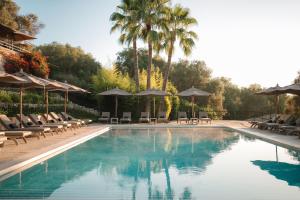 蒙图伊里Finca Serena Mallorca, Small Luxury Hotels的一个带椅子和遮阳伞的游泳池
