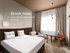 布达佩斯布达佩斯珊特穆诺富特酒店的配有一张床和一张书桌的酒店客房