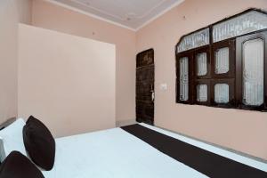 BulandshahrSPOT ON guest house的卧室配有白色的床和窗户。