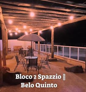 布罗塔斯Brotas Suítes Belo Quinto & Spazzio Bloco 2的庭院配有桌椅和遮阳伞。