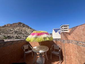阿尔切纳旅游胡安妮塔奥皮公寓的阳台配有桌椅和遮阳伞